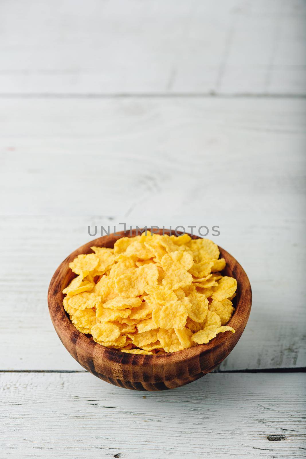 Corn flakes in a wooden bowl by Seva_blsv