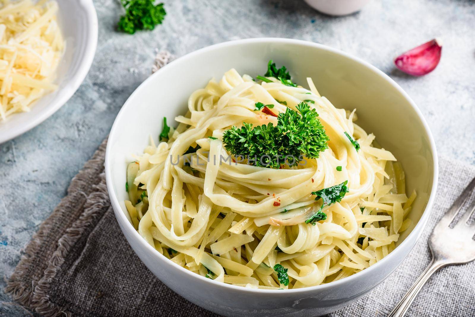 Easy lunch recipe. Linguine pasta with olive oil, garlic, fresh parsley and grated parmesan cheese.