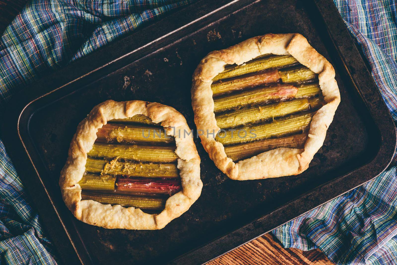 Rhubarb mini galettes on baking sheet by Seva_blsv