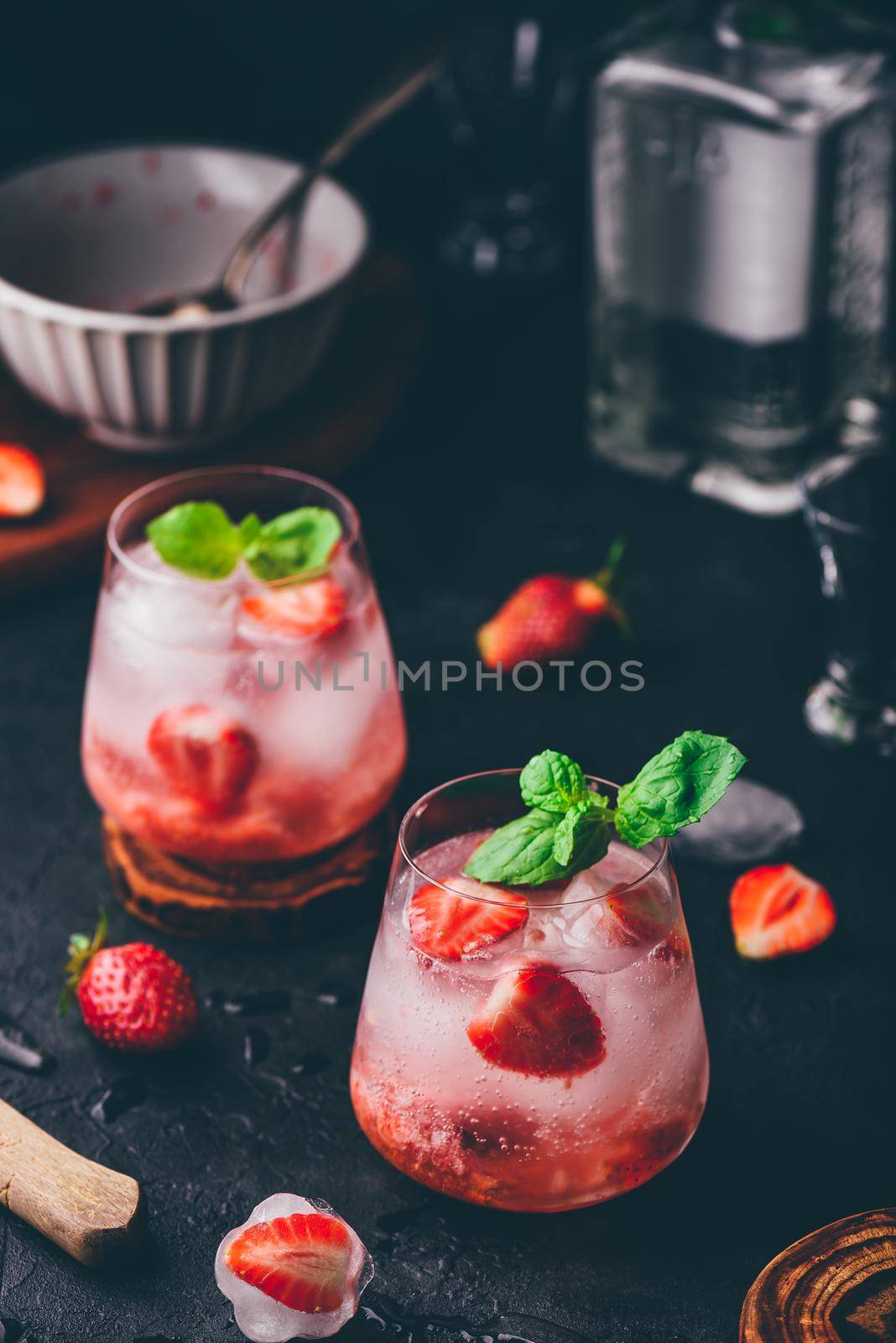 Cocktail with fresh and frozen strawberries, gin and tonic in two glasses