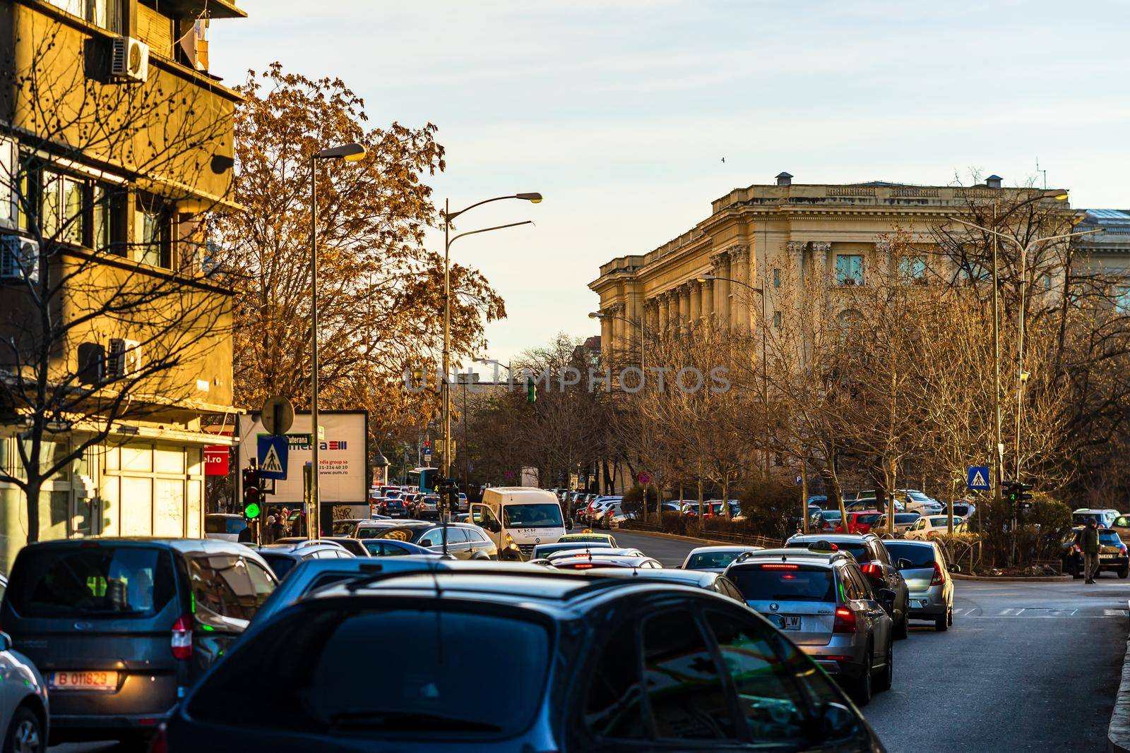 Cars in traffic at rush hour in downtown area of the city. Car pollution, traffic jam in the morning and evening in the capital city of Bucharest, Romania, 2021 by vladispas