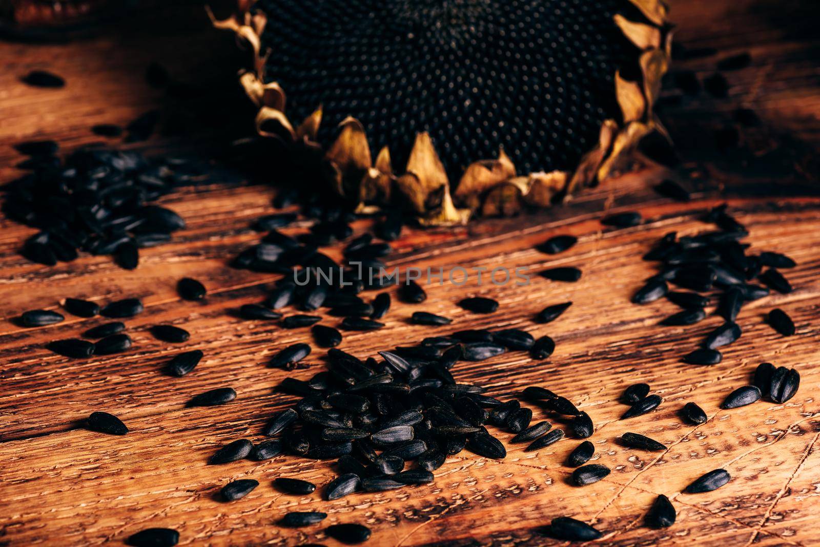 Dried sunflower and roasted seeds on the old wooden table