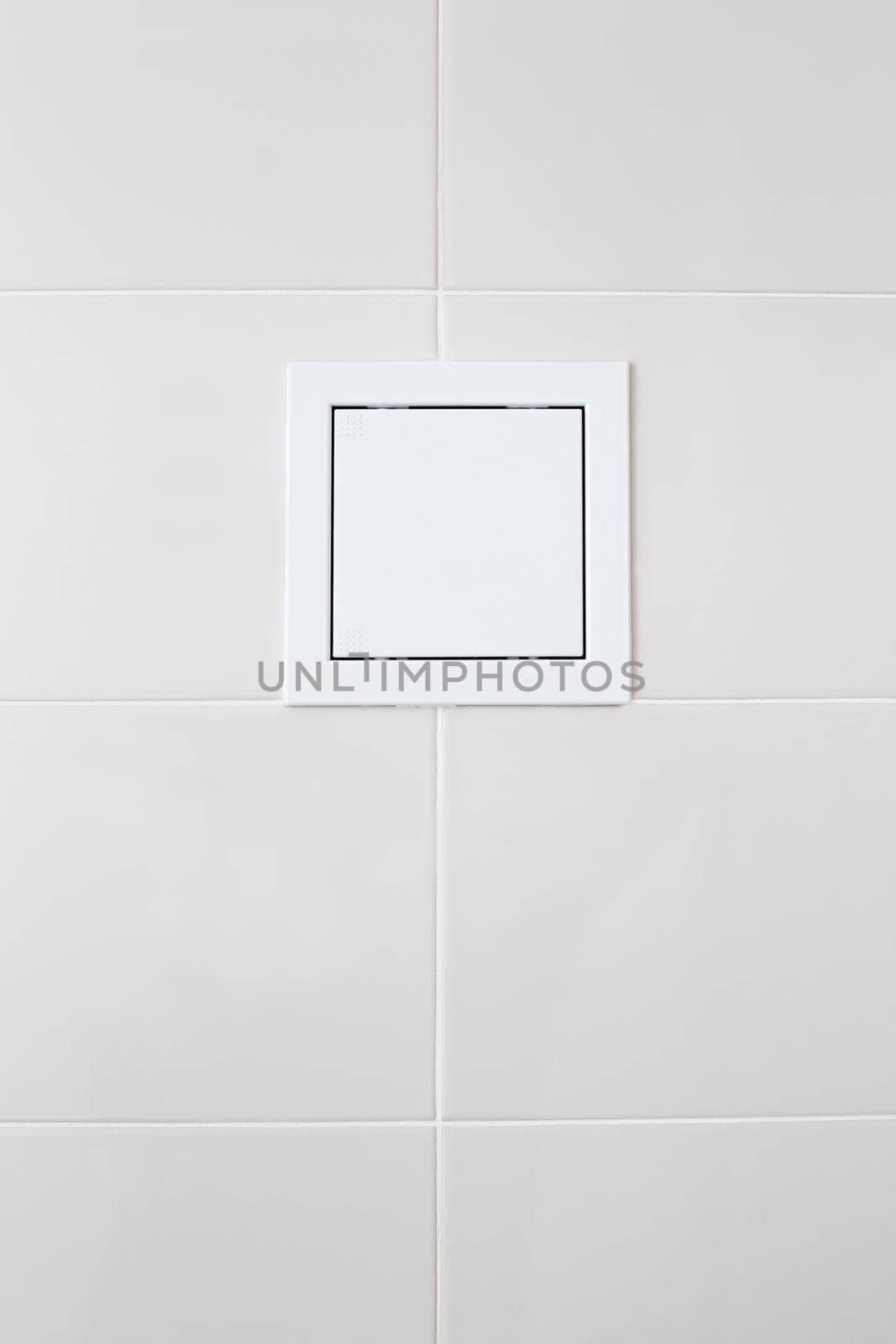 white plastic sunroof with water meters on white tiles on the bathroom wall.