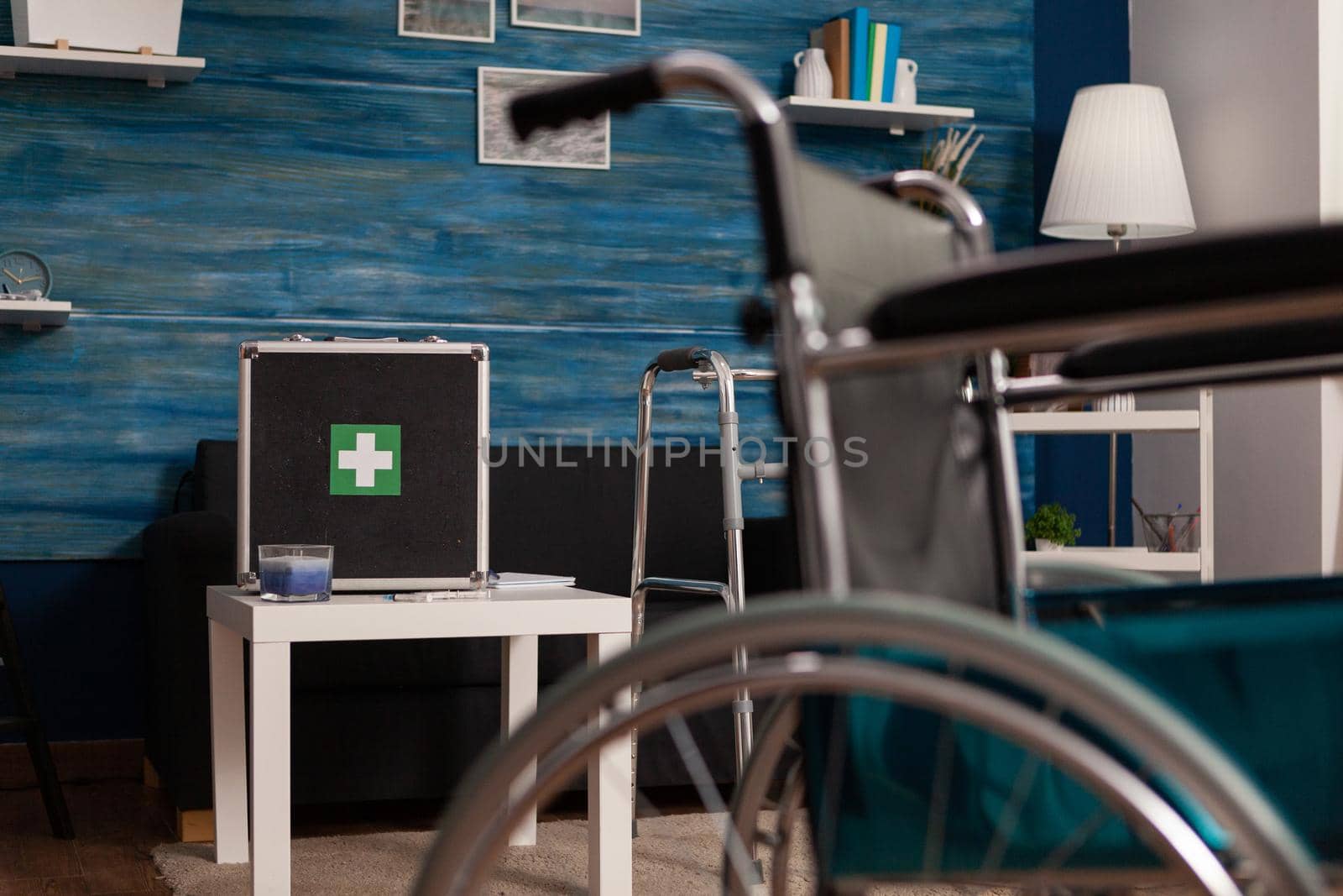 Hospital medical bag equipment standing on table in empty living room with nobody in it by DCStudio