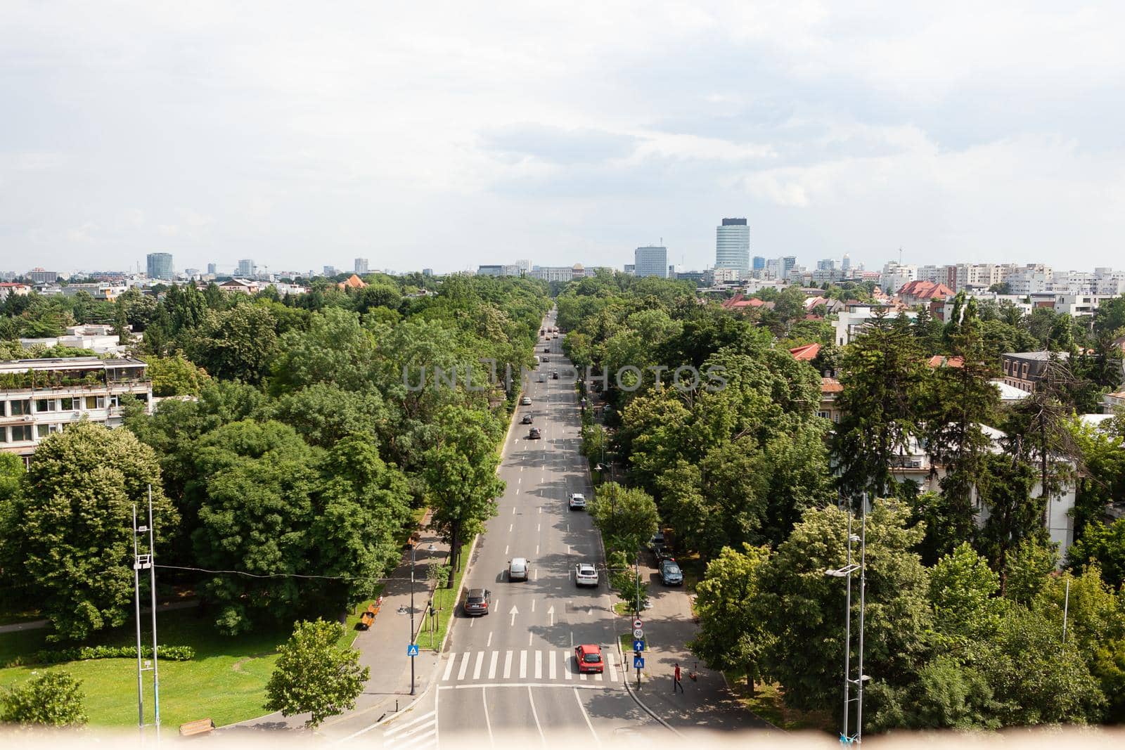 Panoramic view of busy boulevard of metropolitan city during summer days seeing from tower rooftop. Landscape with modern architecture from observation point. Overhead view of street