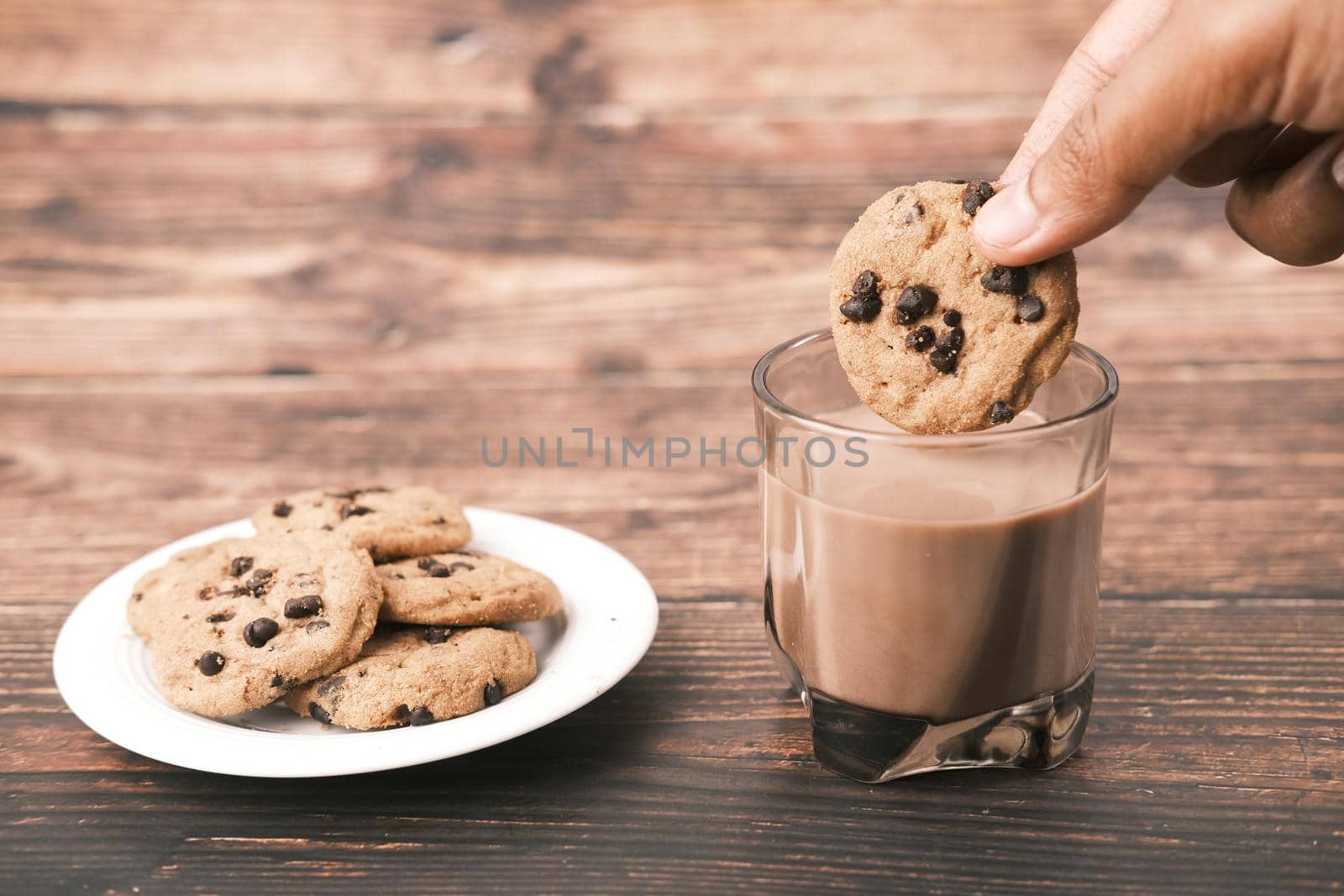 chocolate cooking and a glass of chocolate milkshake on table ,