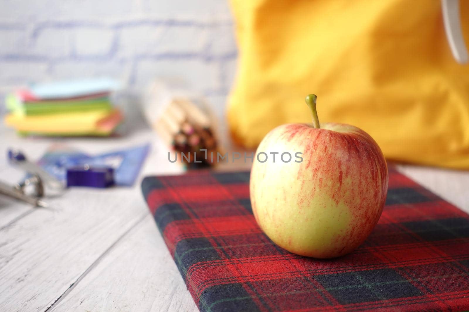 black to school concept with apple on notepad on table
