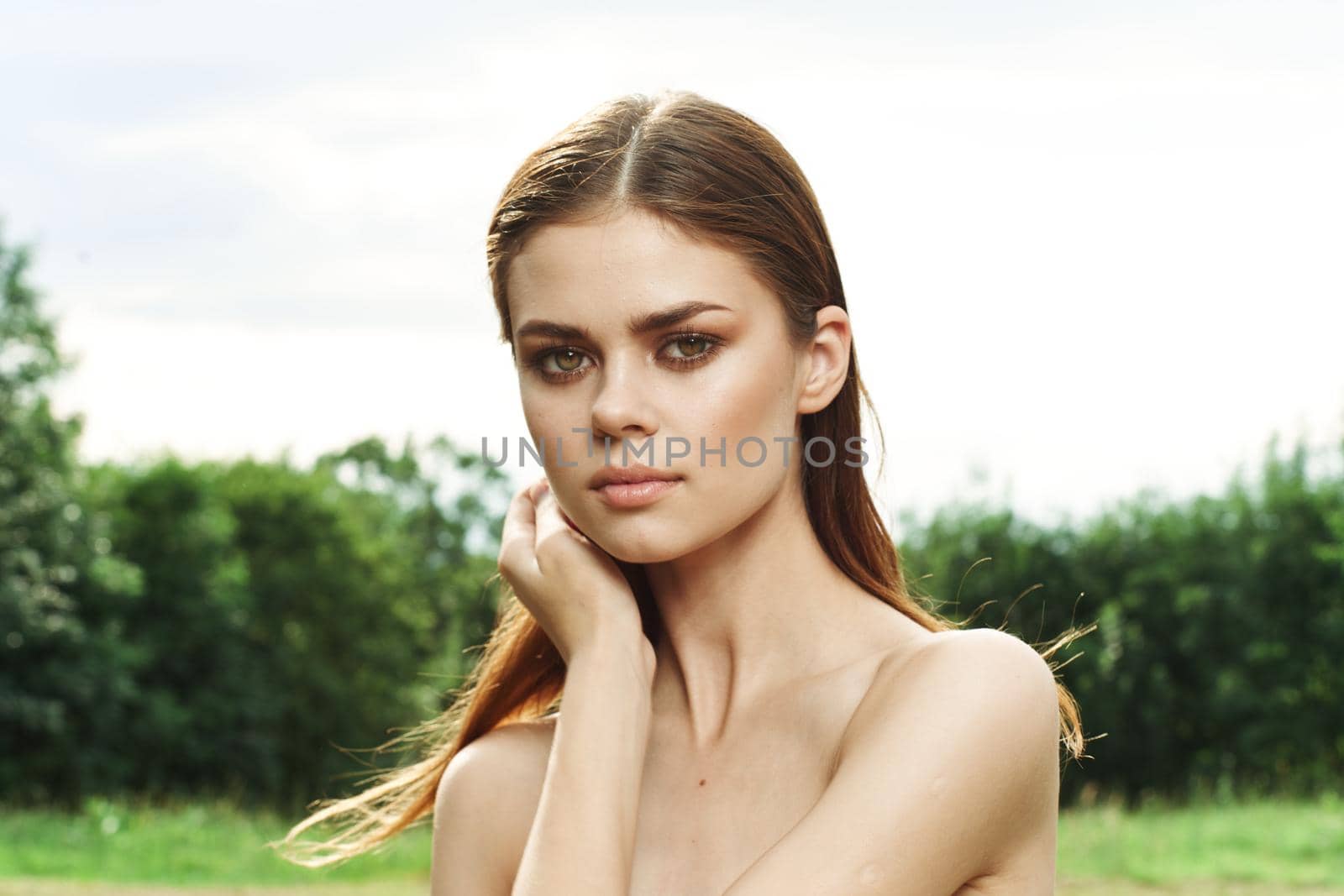 smiling woman attractive look bare shoulders green leaves cropped view. High quality photo