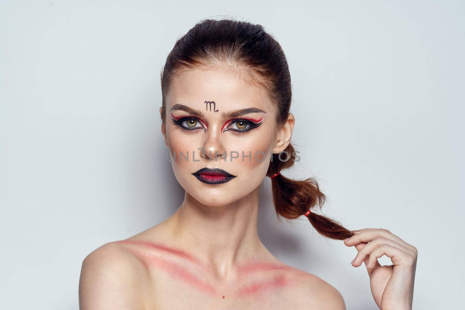 pretty woman naked shoulders cosmetics bright makeup color background. High quality photo