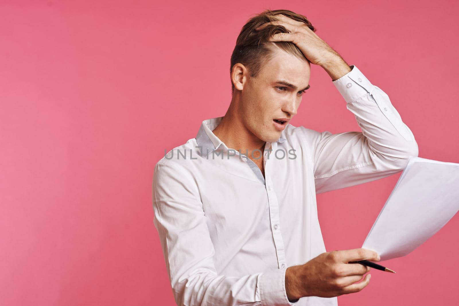 businessmen reading documents in hand pink background. High quality photo