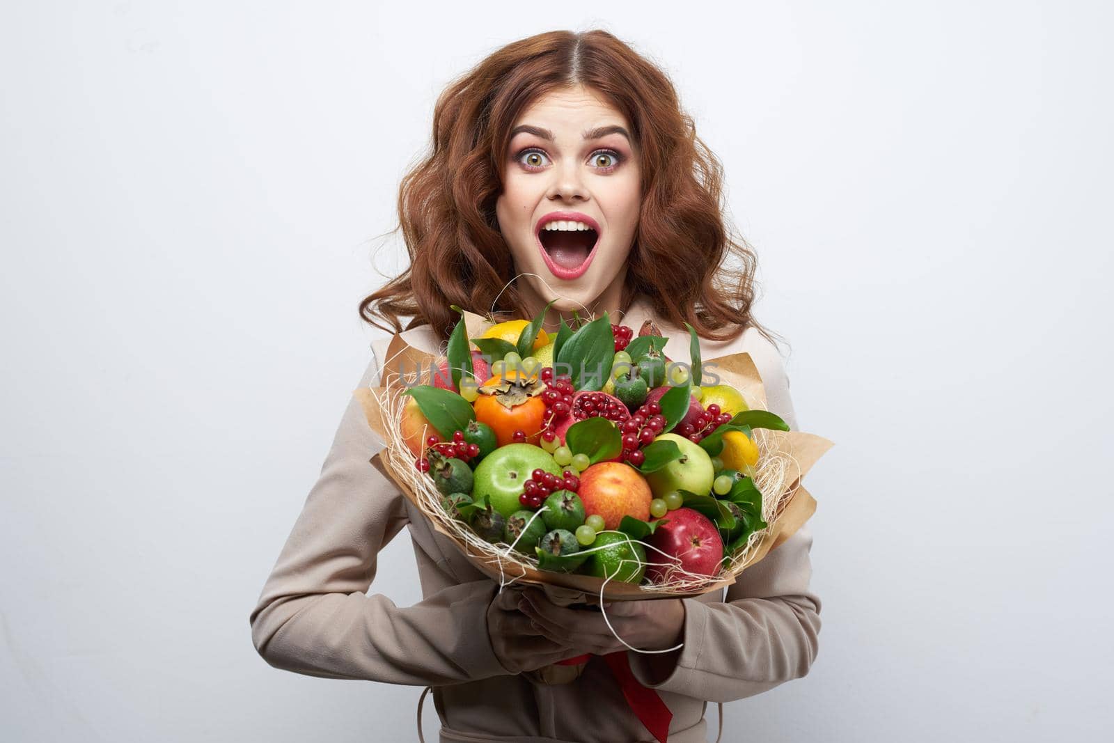 pretty woman bright makeup attractive look a bouquet of fruits light background by Vichizh