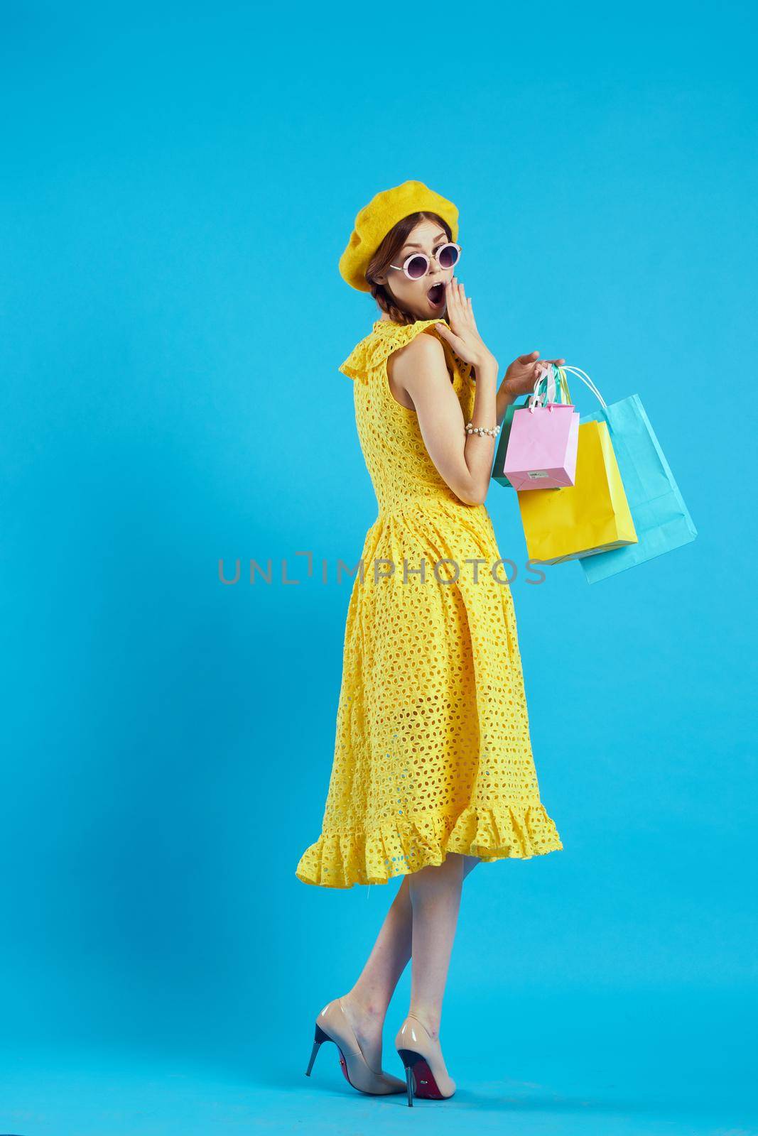 glamorous woman in a yellow hat Shopaholic fashion style isolated background. High quality photo