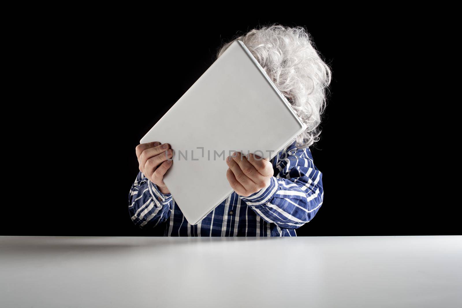 An elderly man does not know how to use the computer by bepsimage