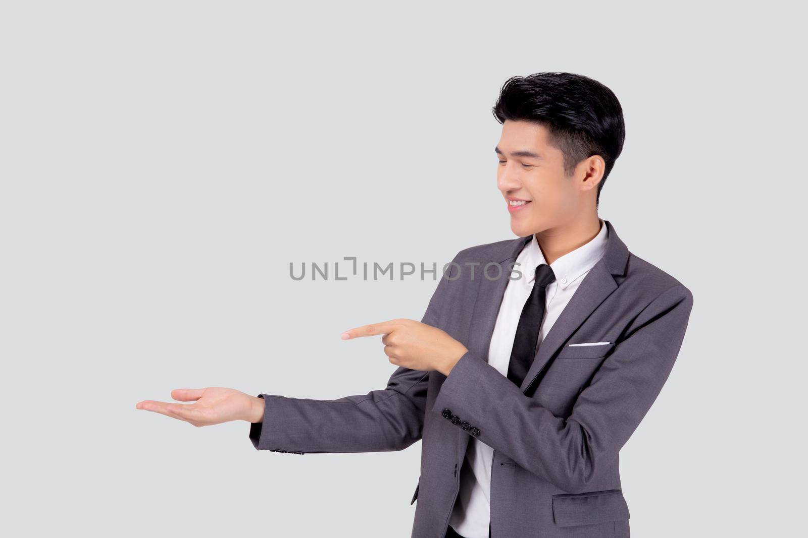 Portrait young asian business man in suit presenting isolated on white background, advertising and marketing, executive and manager, male confident showing success, expression and emotion.