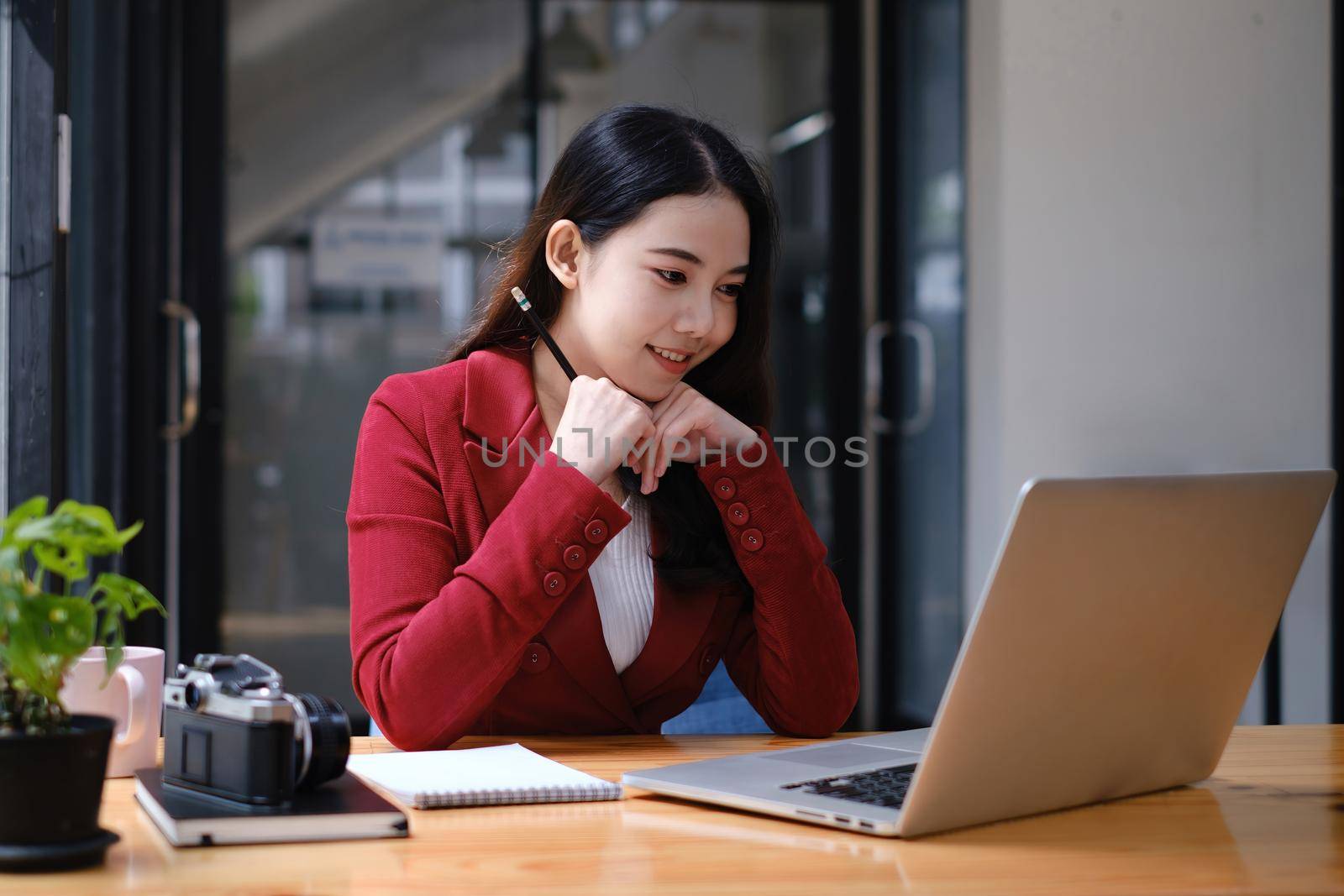 Businesswoman in having a video call on laptop while discussion with business partner during work from home. by itchaznong