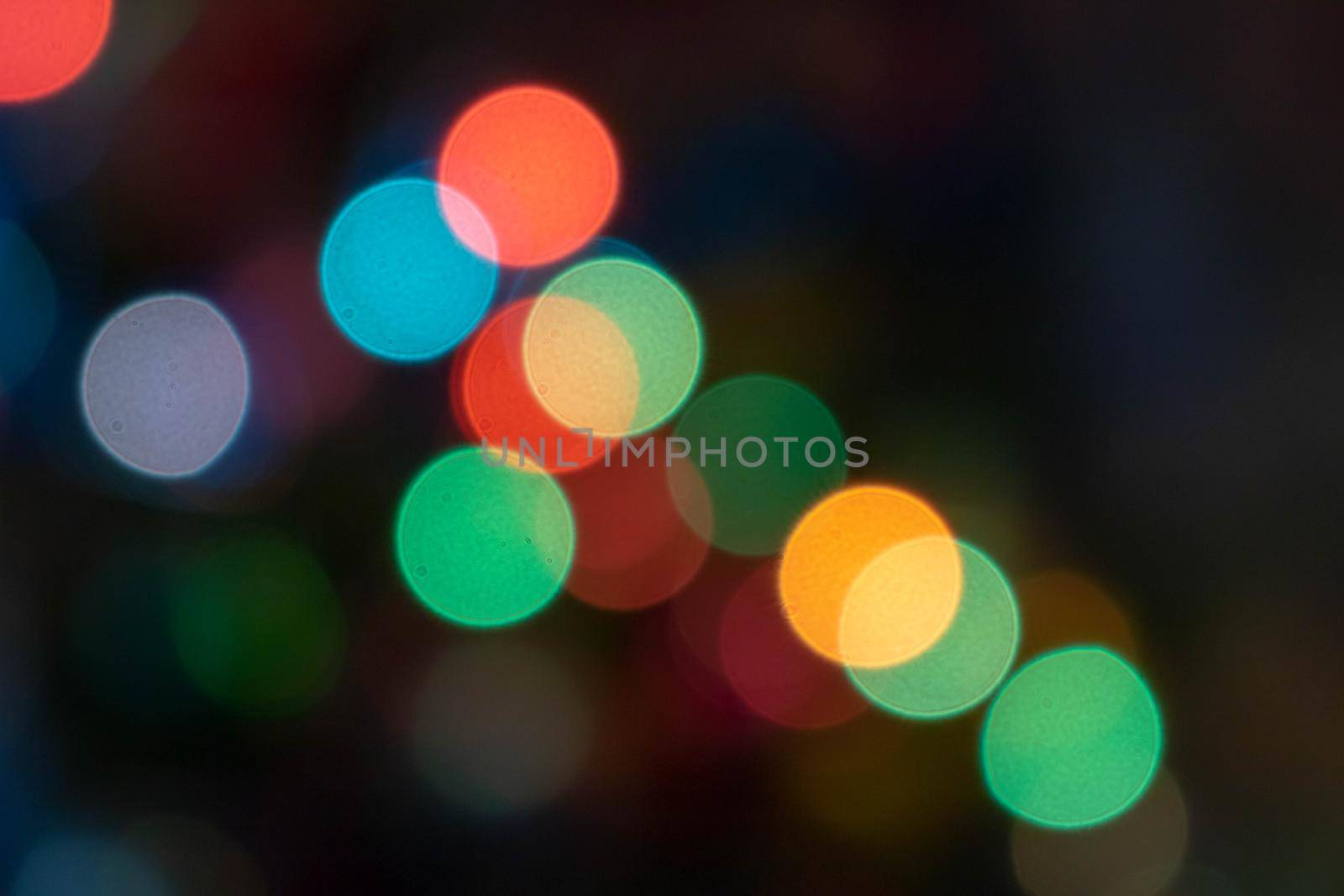 Colorful light bulbs and vivid round bokeh lights tree festive mood lightning. abstract Red glitter lights background. defocused.
