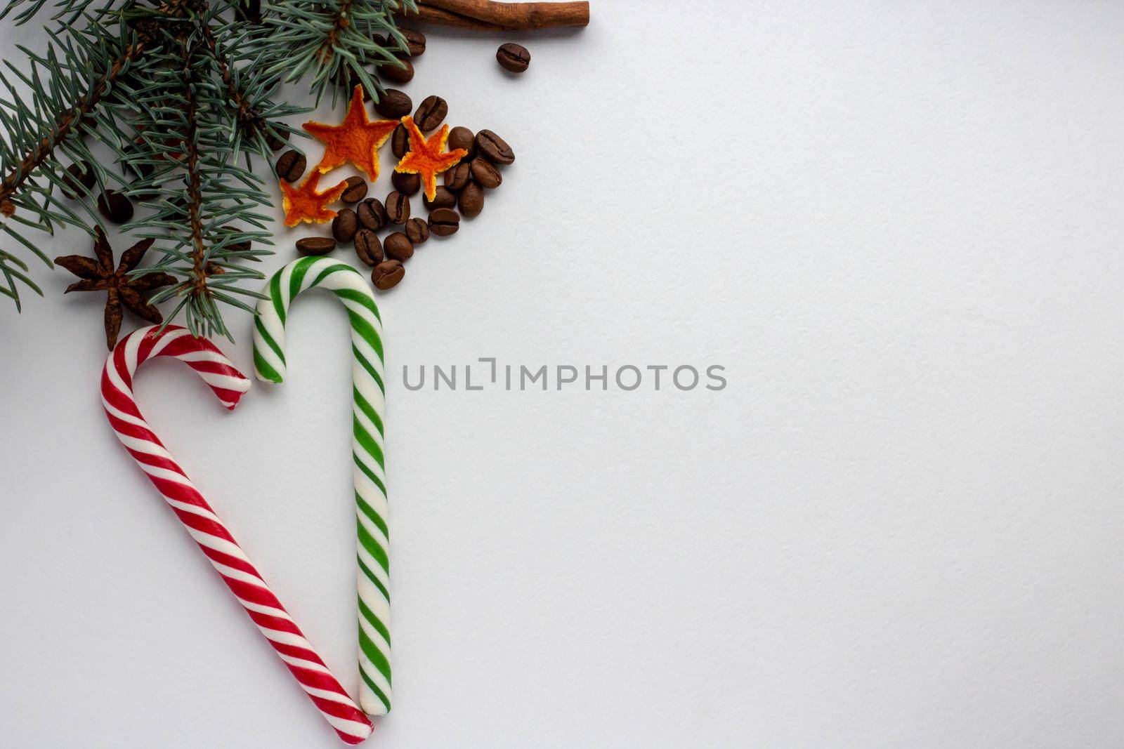 Caramel cane Christmas tree cone rowen branch on white background.new year