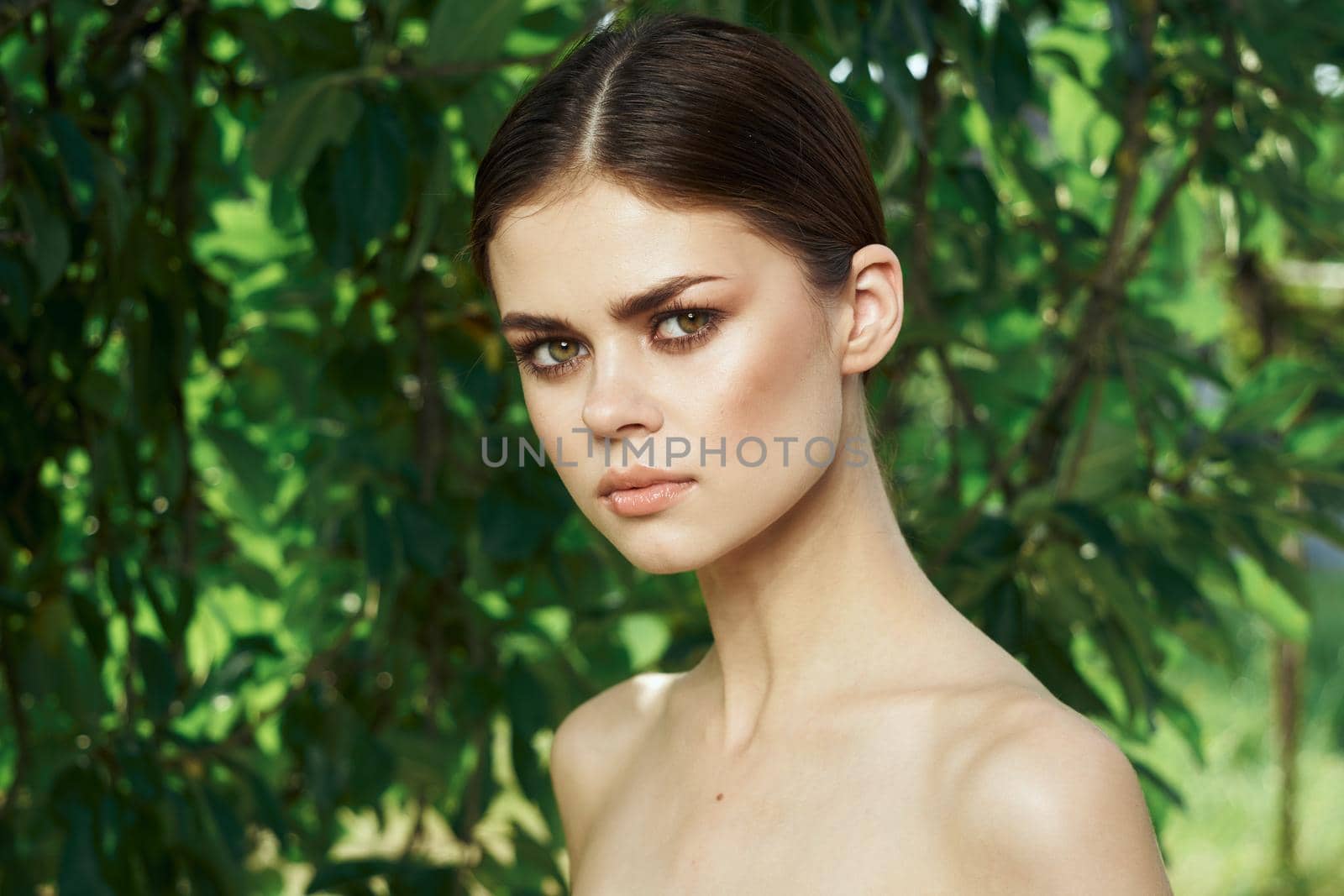 smiling woman attractive look bare shoulders green leaves close-up by Vichizh