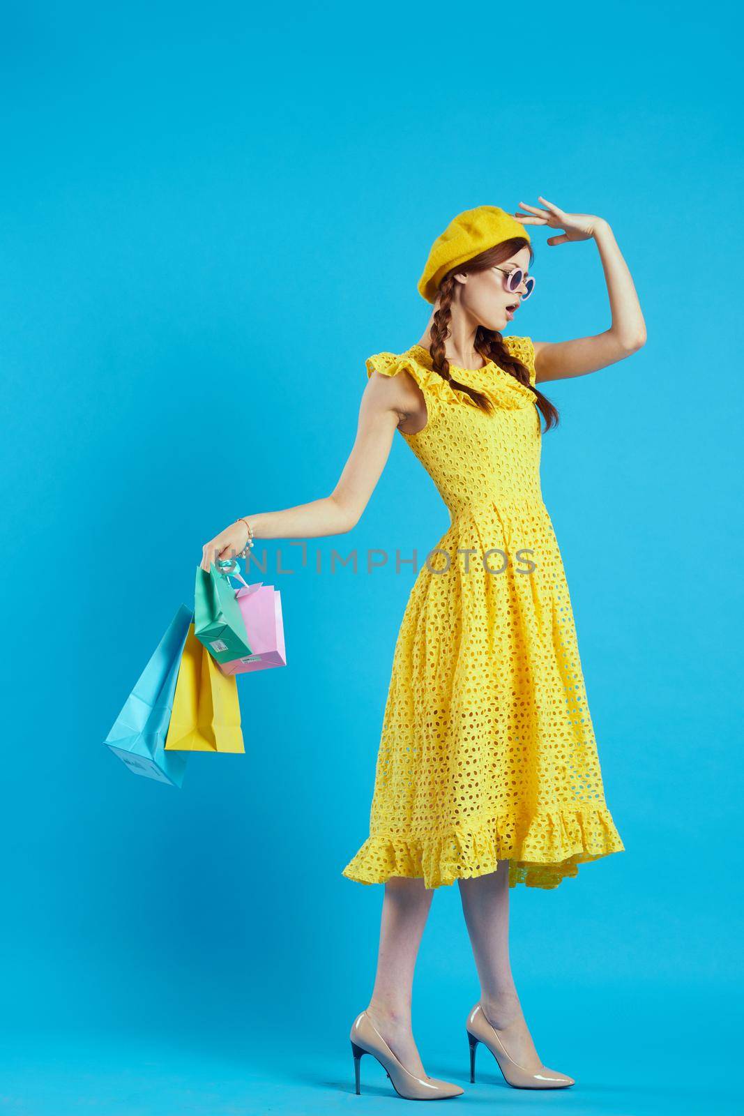 glamorous woman in a yellow hat Shopaholic fashion style isolated background. High quality photo