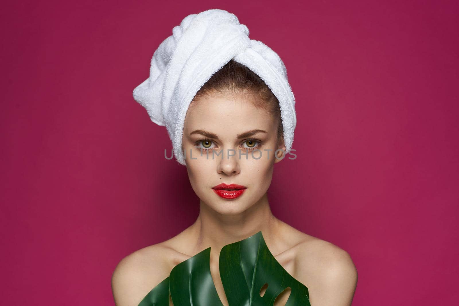 pretty woman bare shoulders red lips posing pink background. High quality photo