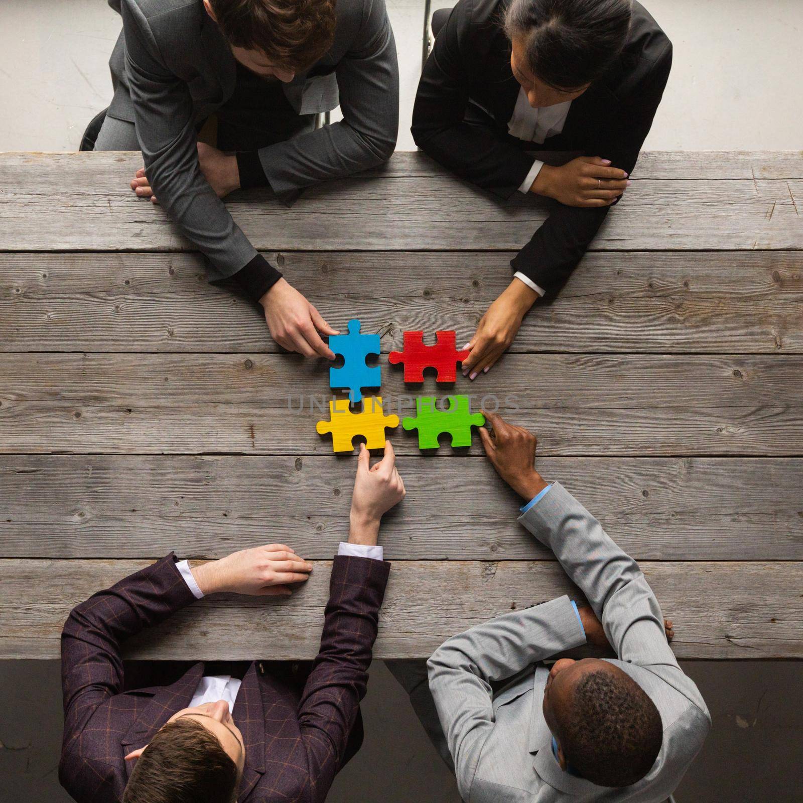 Business teamwork with color puzzle of four pieces cooperation unity concept
