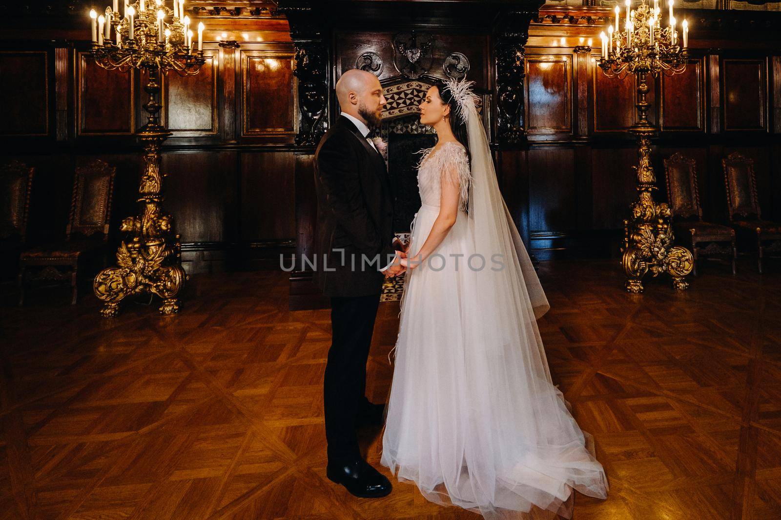 Elegant wedding couple in the interior of the old castle in the city of Nesvizh.