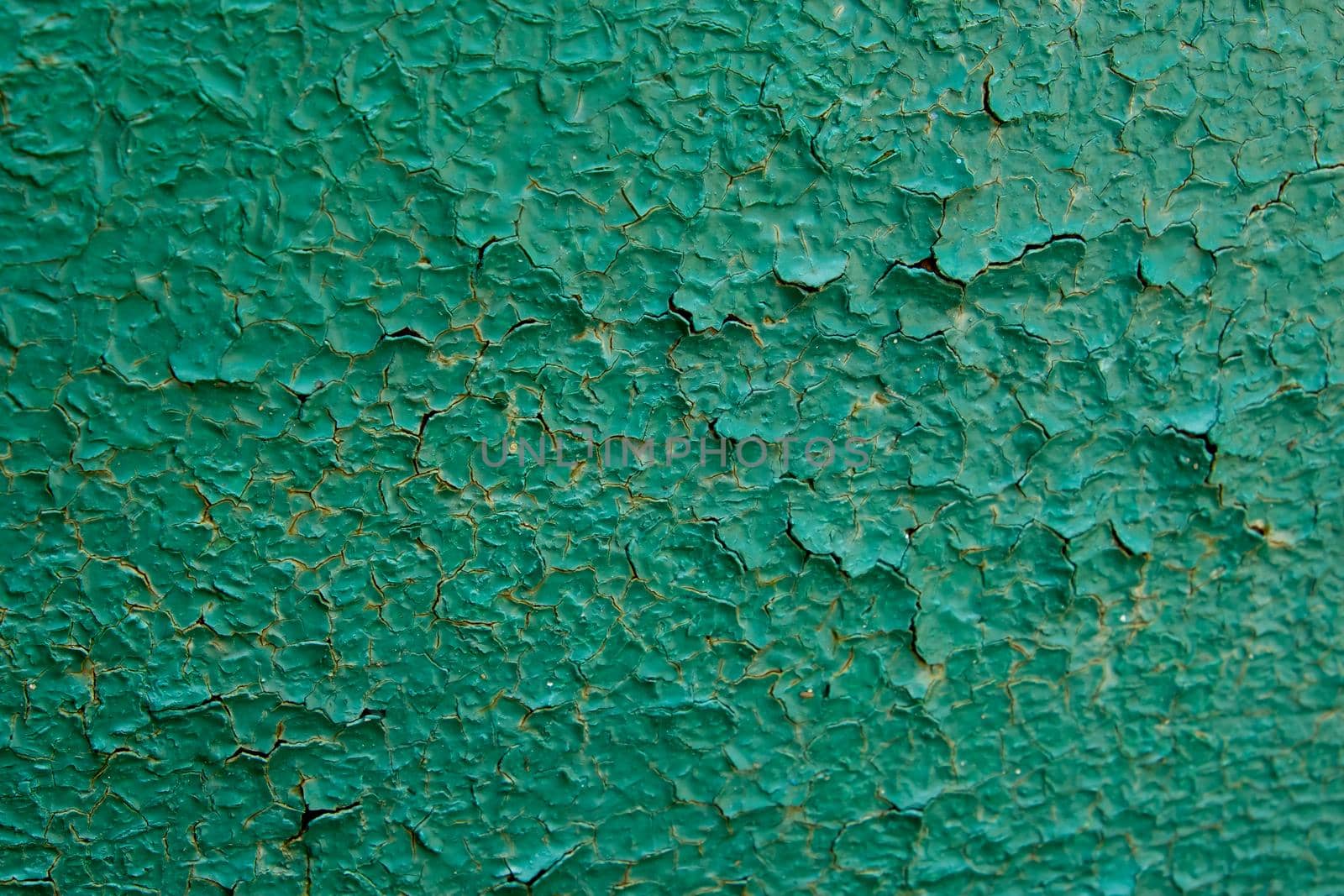 Old green paint on metal board. Texture for backdrop. Close up.