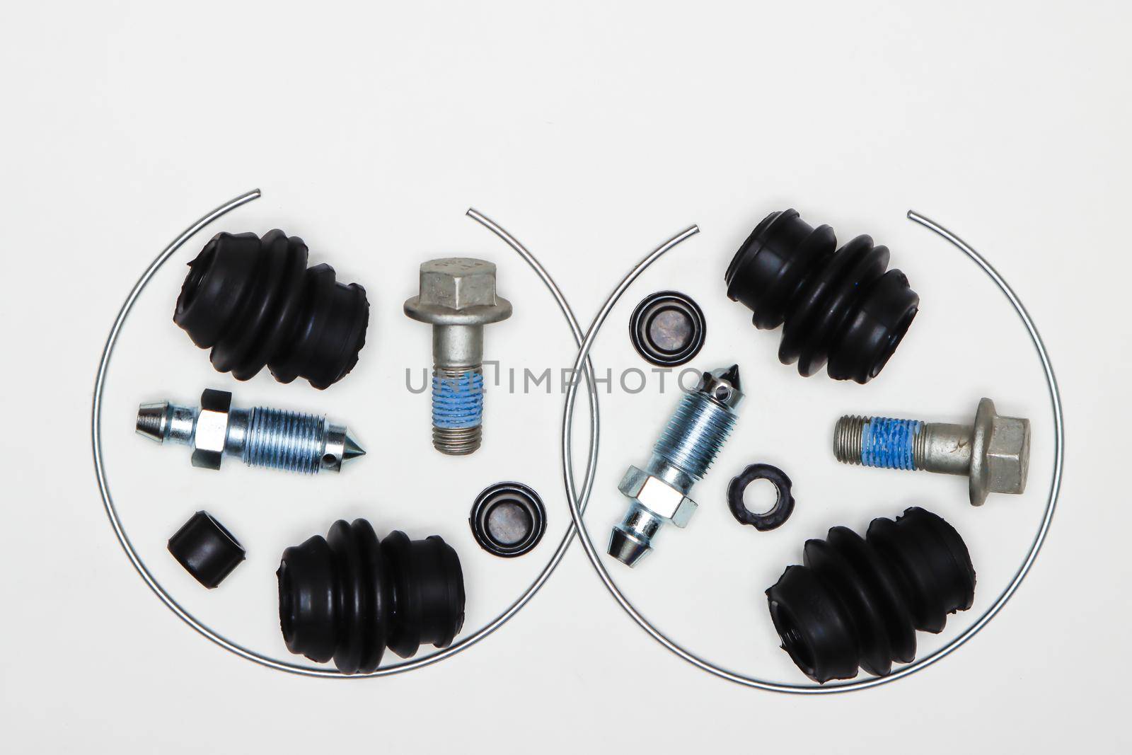 Caliper repair kit, metal retaining rings, union and bolts, rubber seals. Set of spare parts for car brake repair. Details on white background, copy space available. UHD 4K.