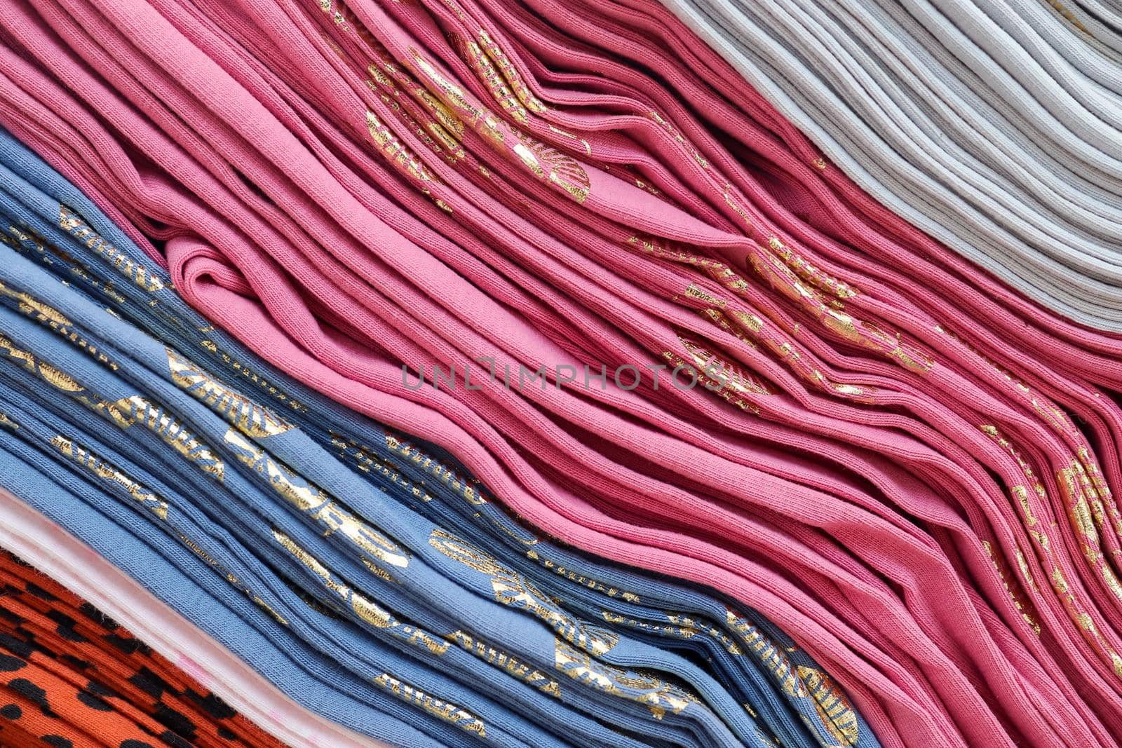 Detailed close up view on samples of cloth and fabrics in different colors found at a fabrics market.