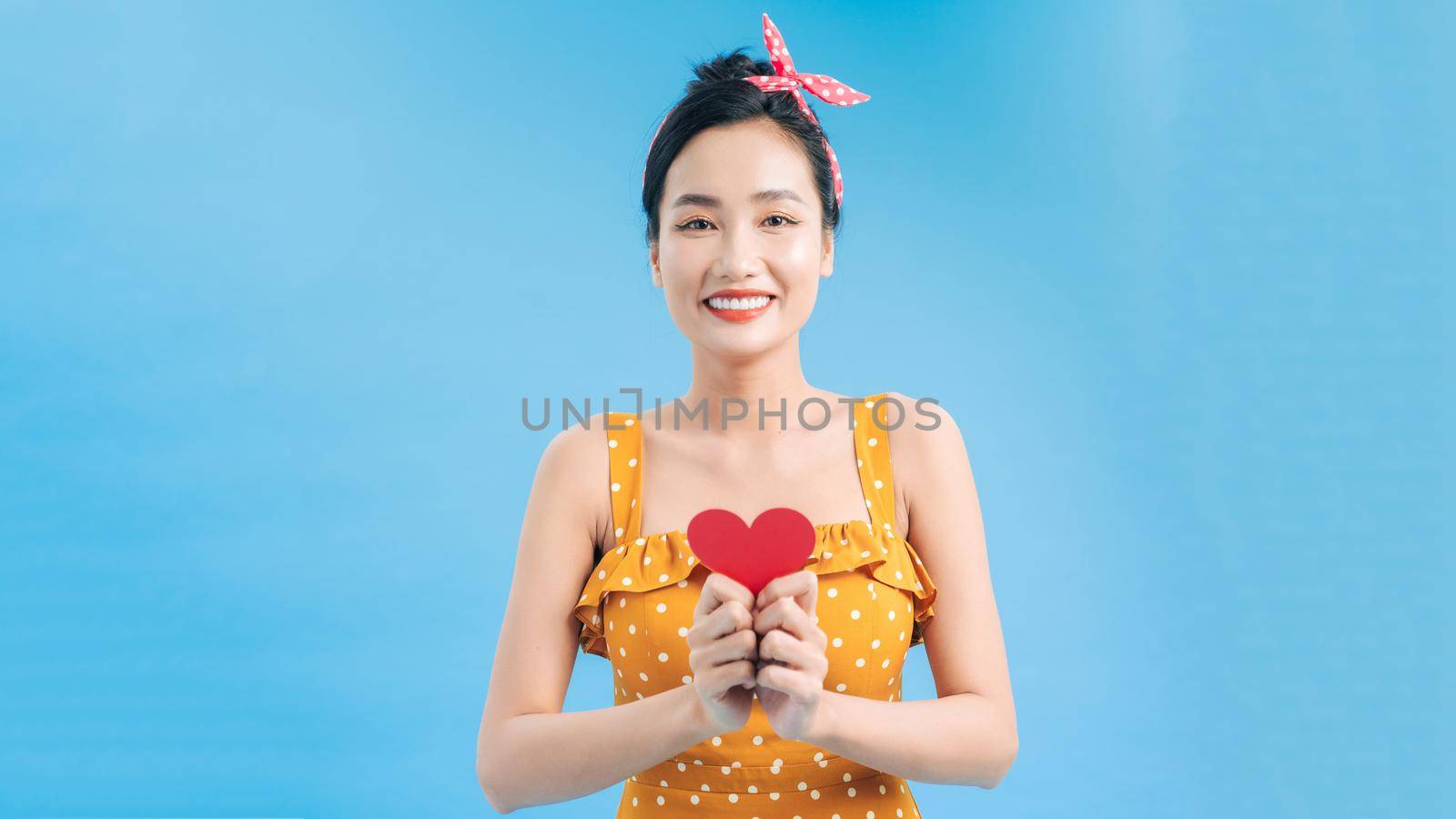 young smile woman hold red heart. valentine day concept. healthy lifestyle