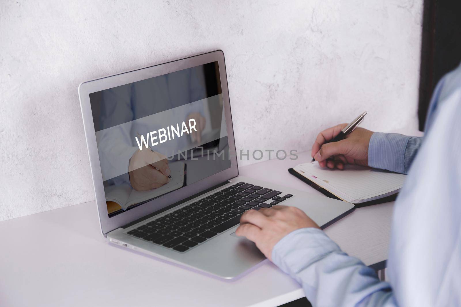 Hand of man watching webinar on laptop computer and writing on notebook for learning, education with e-learning online, video conference and training, seminar course, knowledge and study with digital.