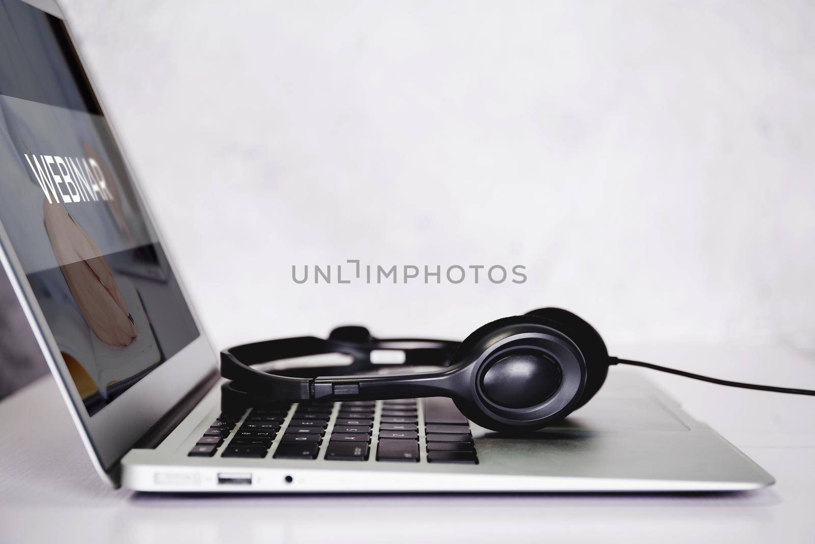 Laptop computer and headphone on desk, e-learning online, webinar for education and learning, seminar with notebook, video conference, headset for multimedia, course and classroom to internet.