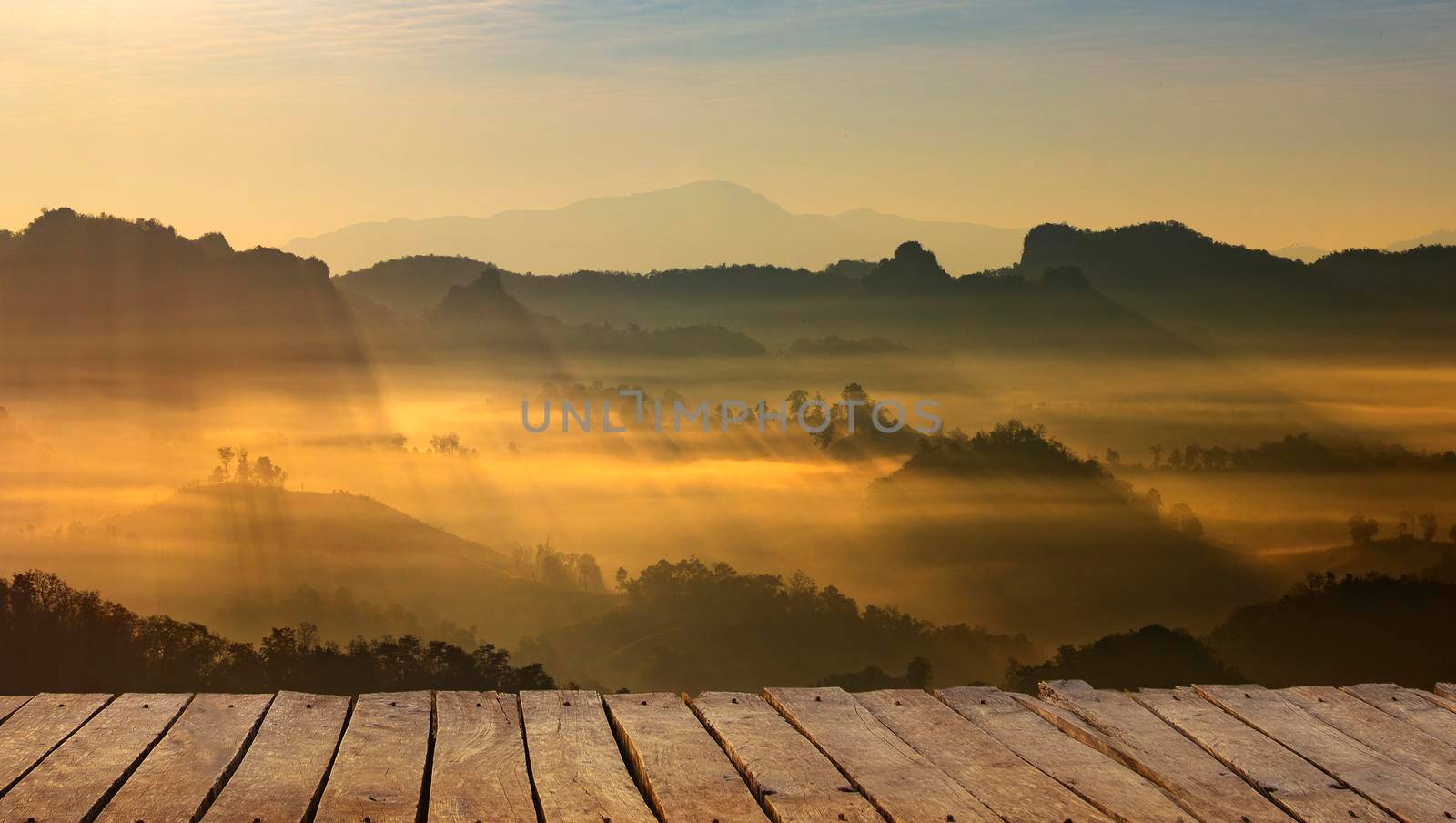 Wooden terrace with mountain landscape and sunrise. by thanumporn