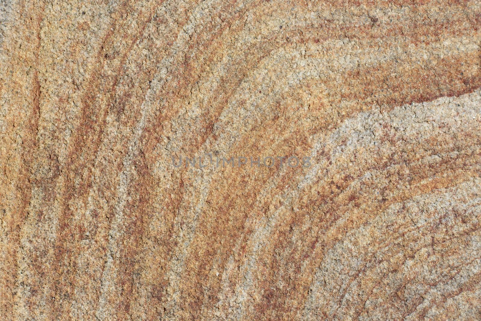 Natural bright stone texture with stripes. Rough textured rock close up with space for text. Weathered grunge granite texture