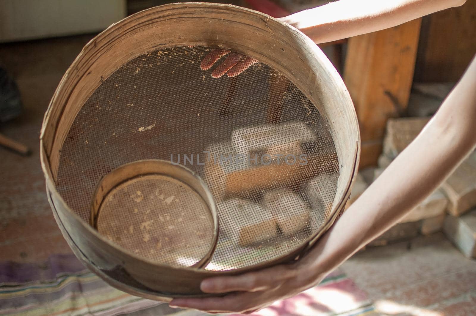 Old sieves, tool for bakery from the past for flour sifting in female hands.