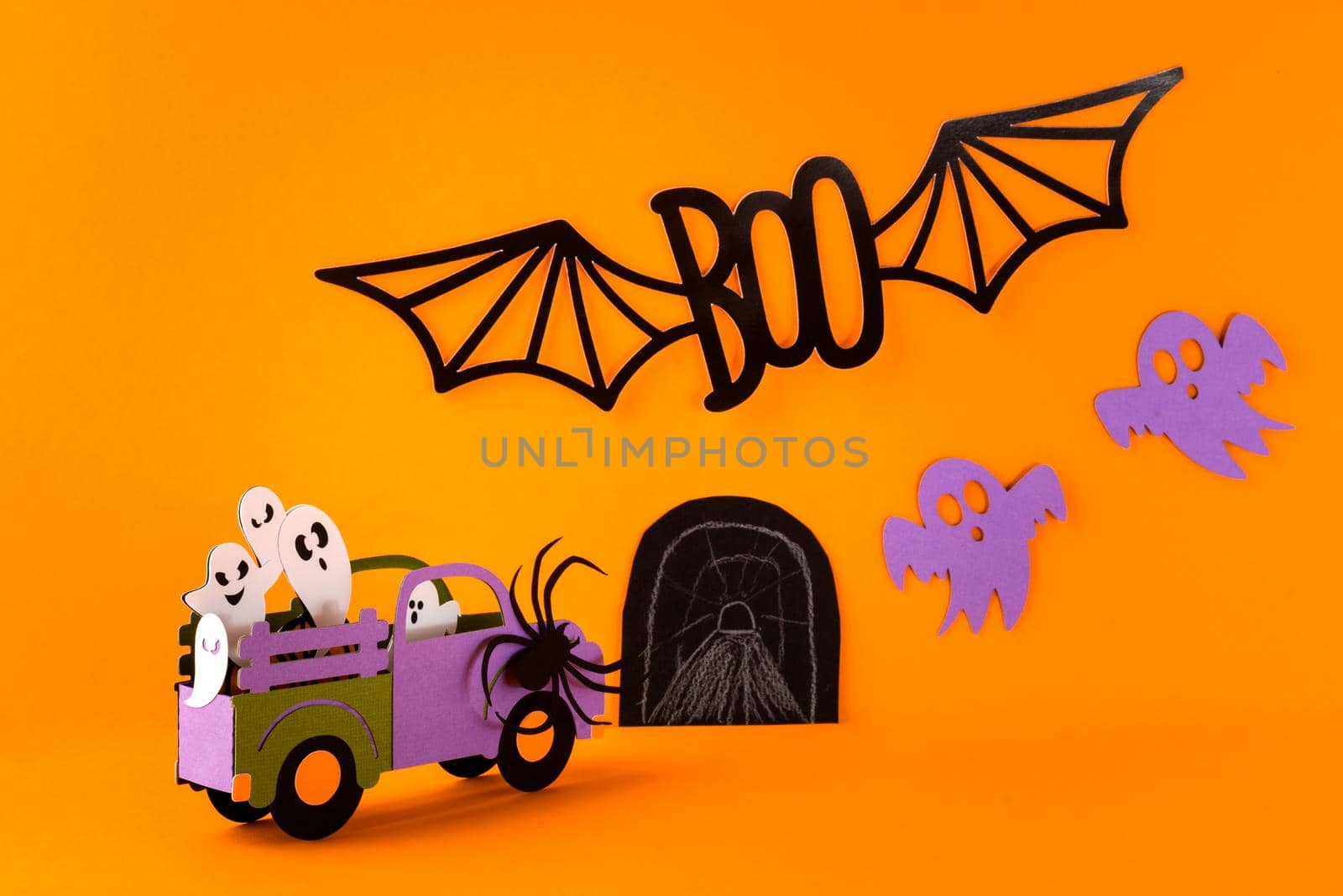 Happy halloween holiday concept. Halloween handmade paper decorations, spiders, ghosts in car, bats, boo text on orange background. Halloween festival party, greeting card mockup with copy space by Ostanina