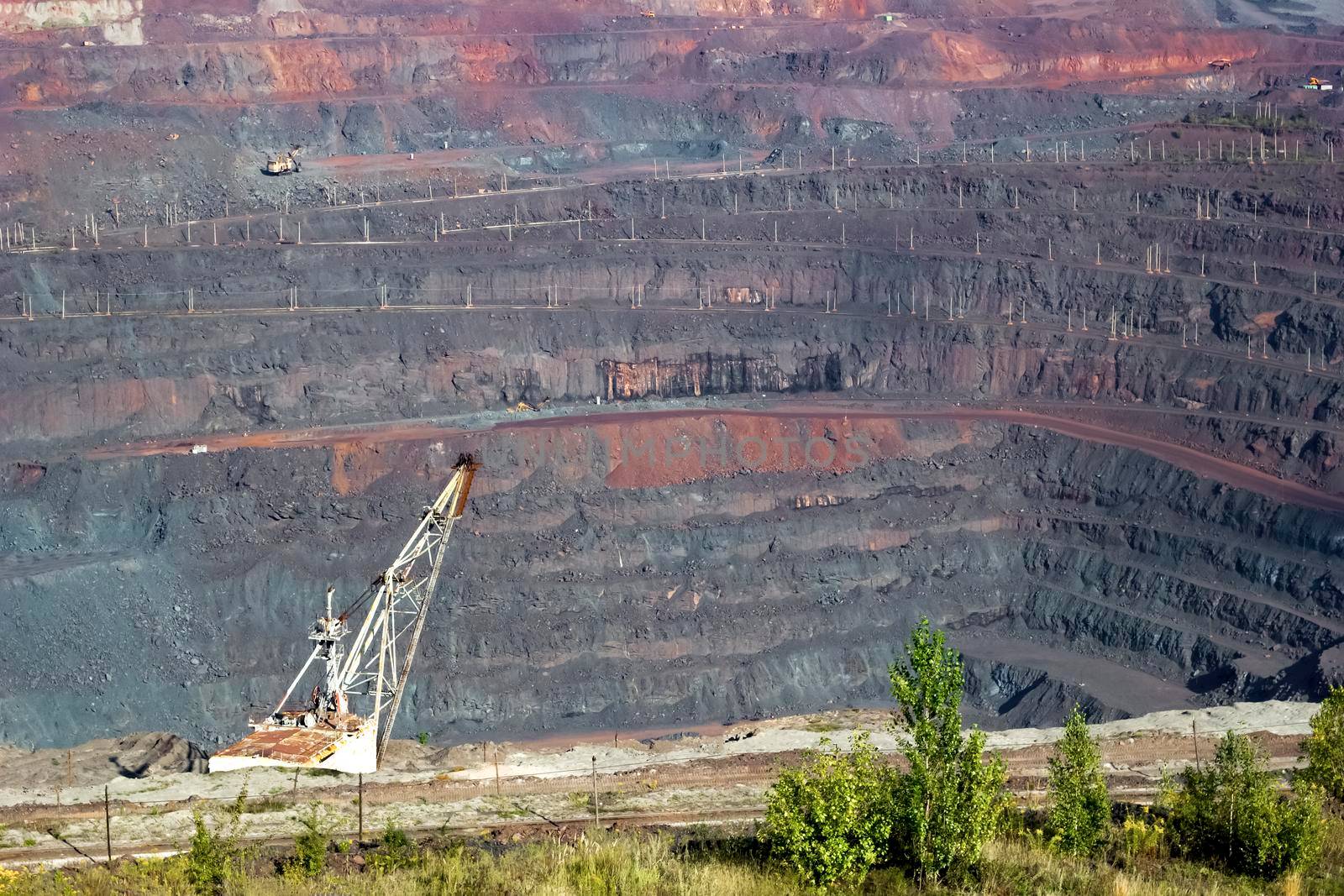 Panorama of an industrial quarry for the extraction of iron ore, top view.