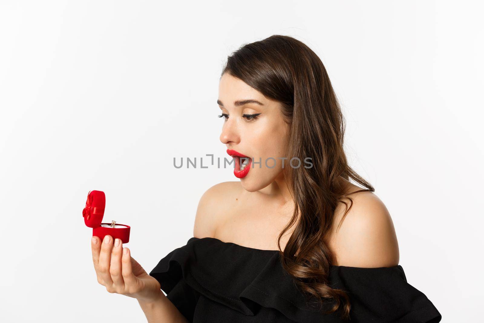 Close-up of surprised woman open box with engagement ring, looking amazed, receiving marriage proposal, girlfriend getting married by Benzoix