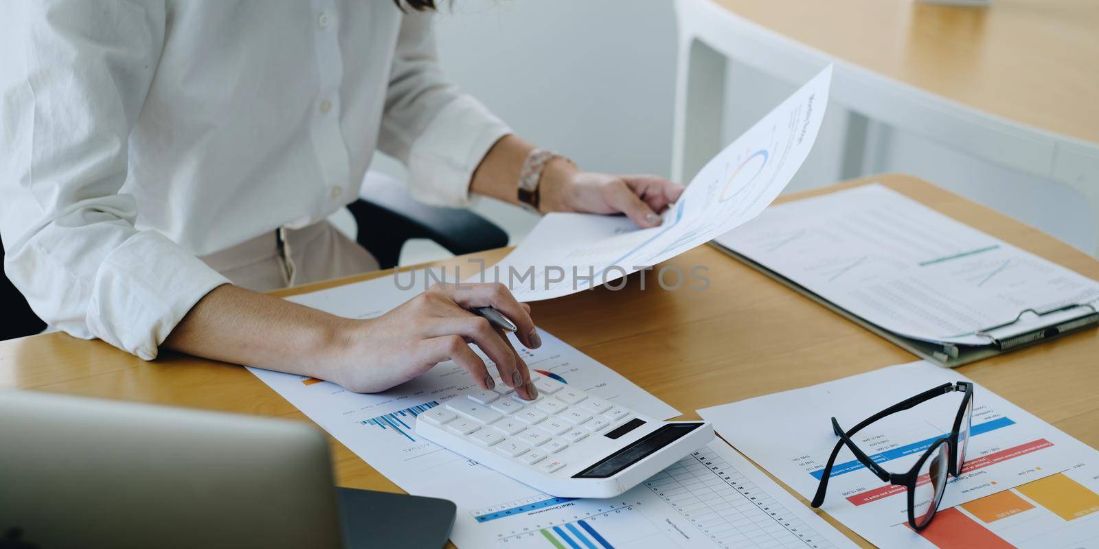 Asian Business woman accountant or banker use calculator and audit finance planning sales to meet targets. by itchaznong