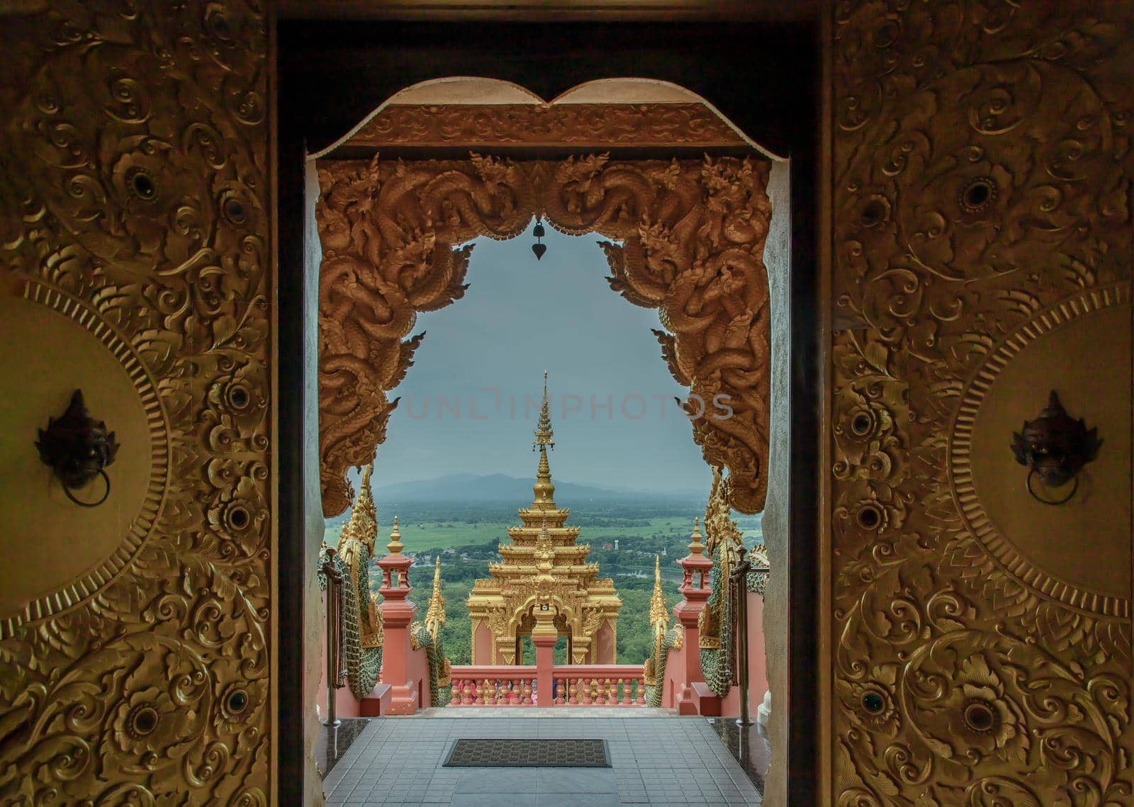 Forest landscape under cloudy blue sky from gate of Wat Phra That Doi Phra Chan in Lampang.  by tosirikul