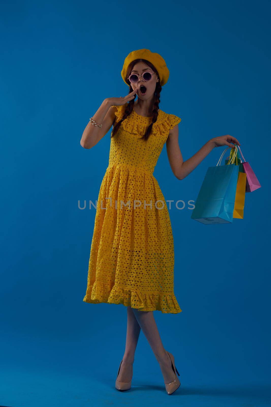 smiling woman in a yellow hat Shopaholic fashion style blue background by Vichizh