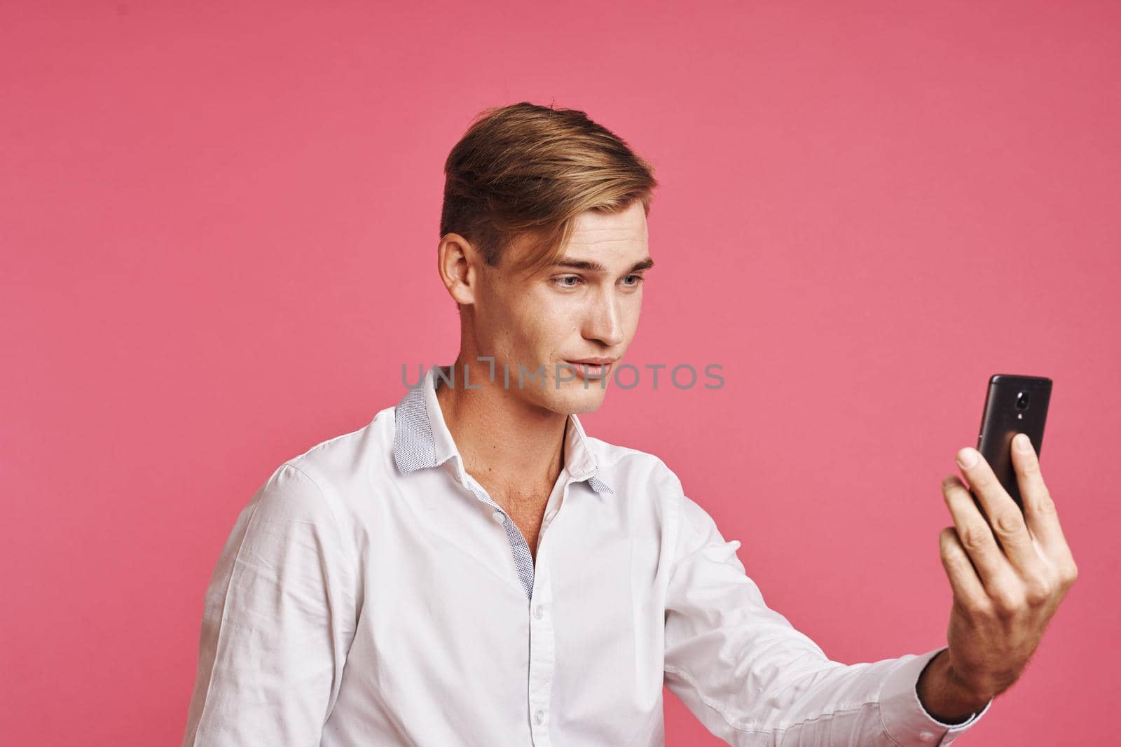 handsome man technology communication emotions pink background by Vichizh