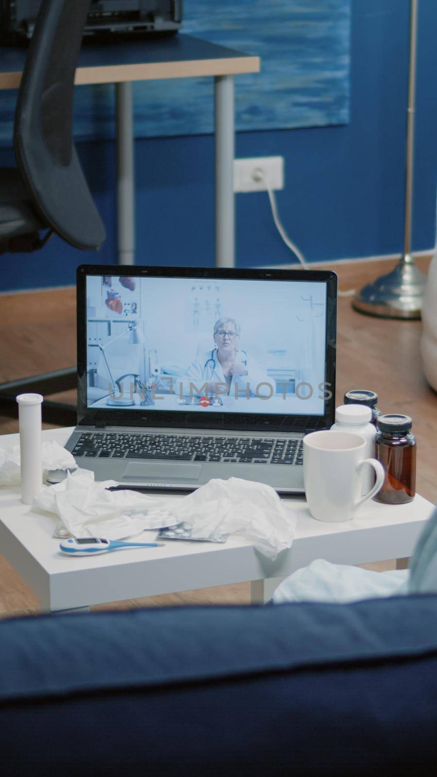 Sick adult having medical consultation with doctor on video call conference at home. Woman using laptop for remote communication with healthcare specialist, asking about disease treatment