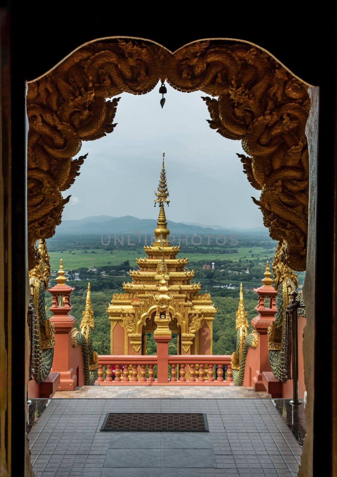 Forest landscape under cloudy blue sky from gate of Wat Phra That Doi Phra Chan in Lampang.  by tosirikul