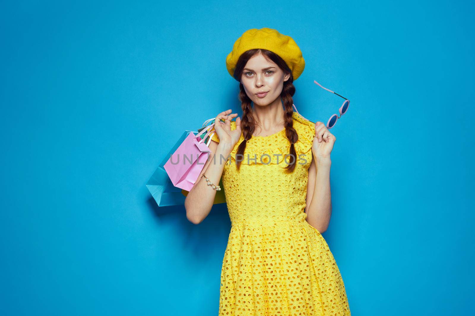 smiling woman in a yellow hat Shopaholic fashion style isolated background. High quality photo