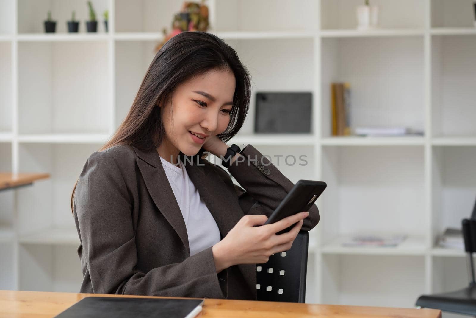 Happy asian woman using smart phone for business, online shopping, transfer money, financial, internet banking. in coffee cafe shop. by nateemee