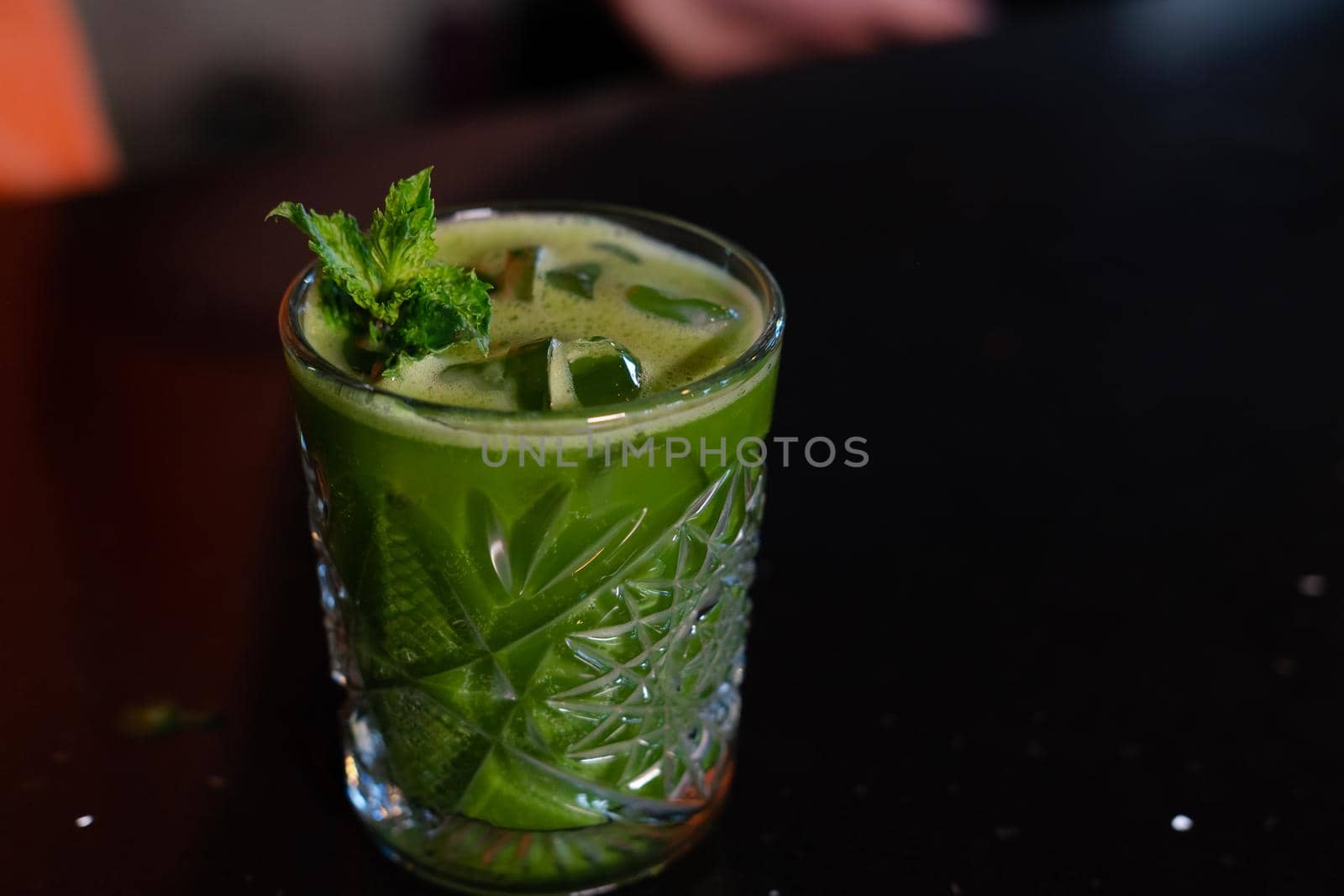 matcha cocktail or tea or latte with ice and mint isolated on black background. modern drinks. trendy cocktail.