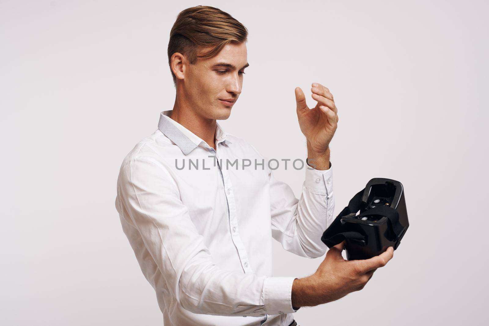 portrait of a man virtual reality glasses high-tech simulator isolated background. High quality photo