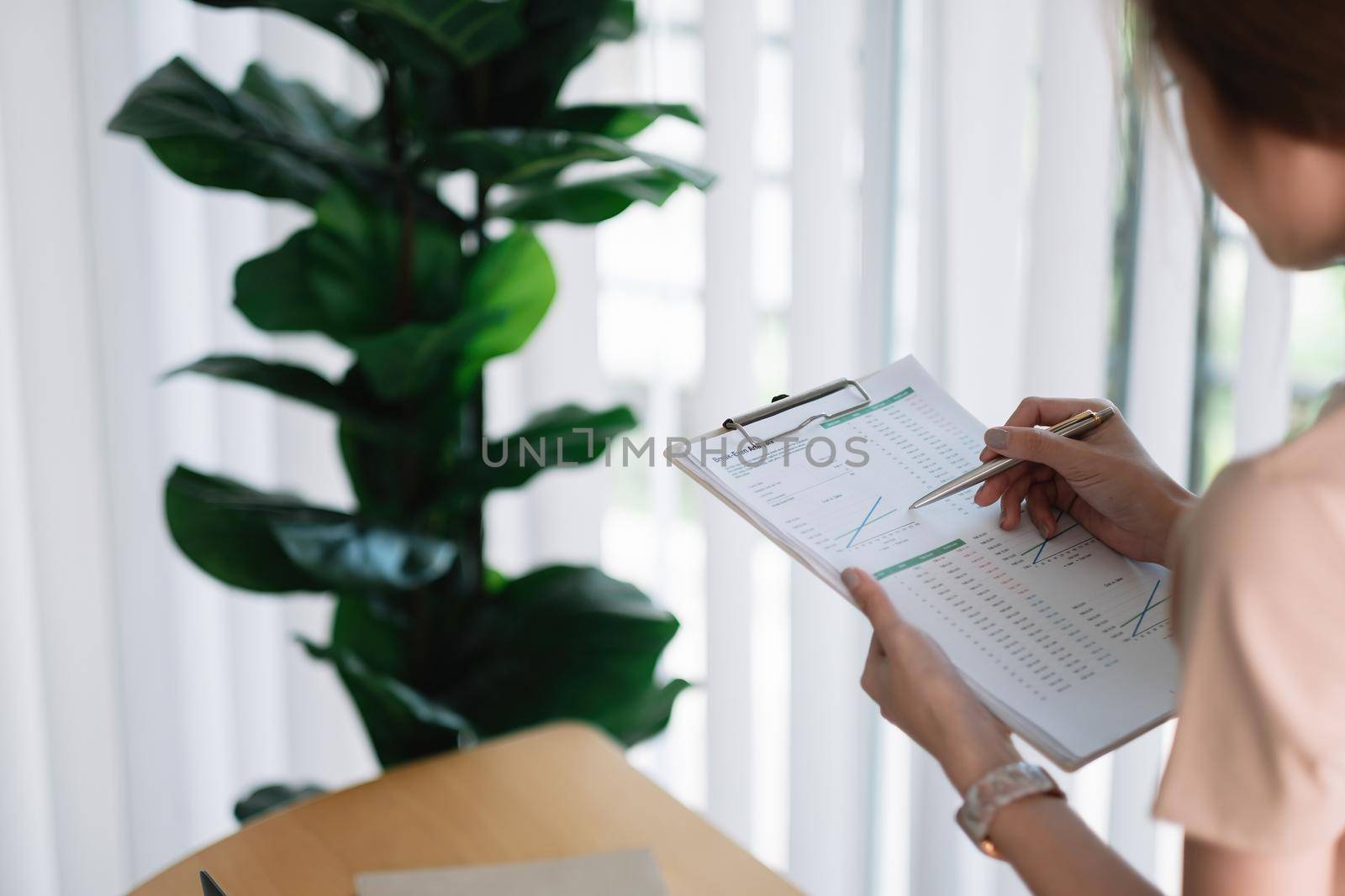 Close up accounting woman working with paperwork and calculate the numbers, finance accounting concept.