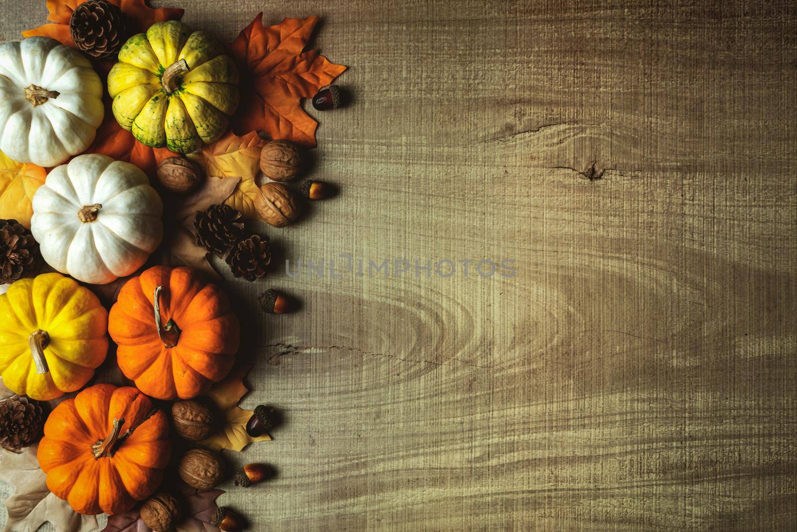 Happy Thanksgiving Day with pumpkin and nut on wooden table